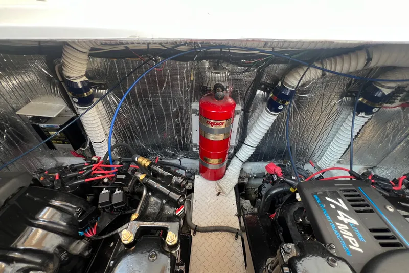 Slide: The Image of Engine room of 2001 Cruisers Yachts 3672 Express with fire extinguisher and mechanical components. - 36