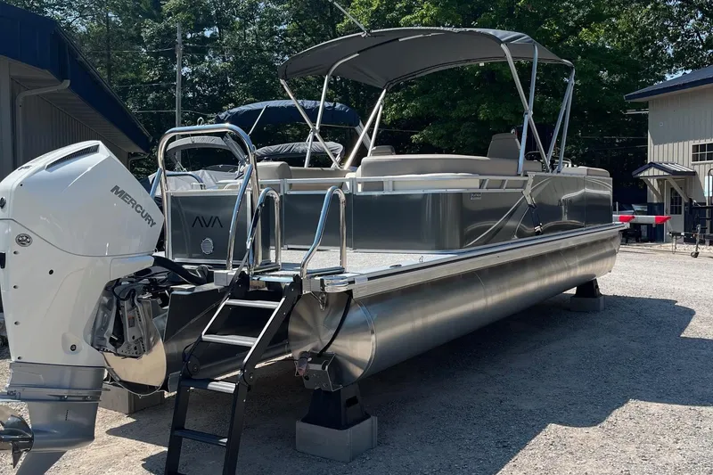 The Image of 2026 Avalon 25 LSZ Quad Lounger pontoon boat with Mercury engine, parked outdoors. - 1