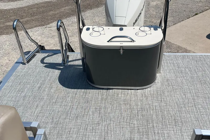 Slide: The Image of 2026 Avalon 25 LSZ Quad Lounger boat deck with motor and seating area. - 3