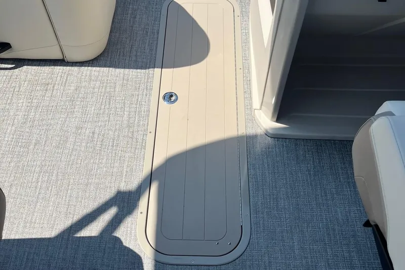 Slide: The Image of 2026 Avalon 25 LSZ Quad Lounger interior flooring with storage compartment. - 6