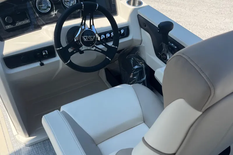 Slide: The Image of 2026 Avalon 25 LSZ Quad Lounger interior with steering wheel and controls. - 7
