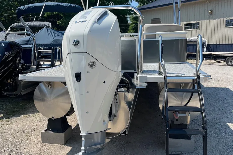 Slide: The Image of 2026 Avalon 25 LSZ Quad Lounger pontoon boat with powerful outboard motor and rear ladder. - 9