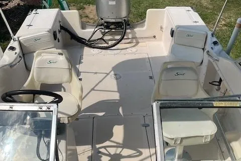 Slide: The Image of 1996 Scout 202 Dorado boat interior with seating and steering wheel. - 14