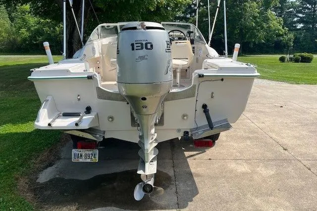 Slide: The Image of 1996 Scout 202 Dorado boat with Honda 130 outboard motor on driveway. - 3