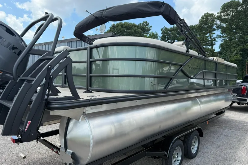 Slide: The Image of 2026 Bentley Pontoons Legacy 243 Navigator on trailer, outdoor setting. - 1