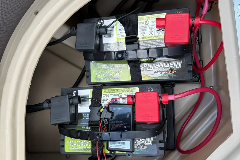 Slide: The Image of Dual marine batteries in a 2026 Bentley Pontoons Legacy 243 Navigator boat. - 11