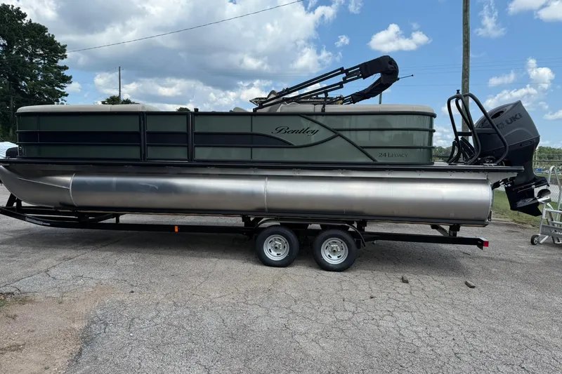 Slide: The Image of 2026 Bentley Pontoons Legacy 243 Navigator on trailer under cloudy sky. - 3