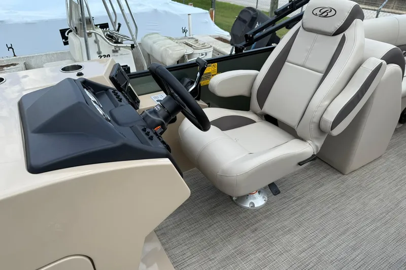 Slide: The Image of Captain's chair and helm of 2026 Bentley Pontoons Legacy 243 Navigator, featuring modern controls. - 4