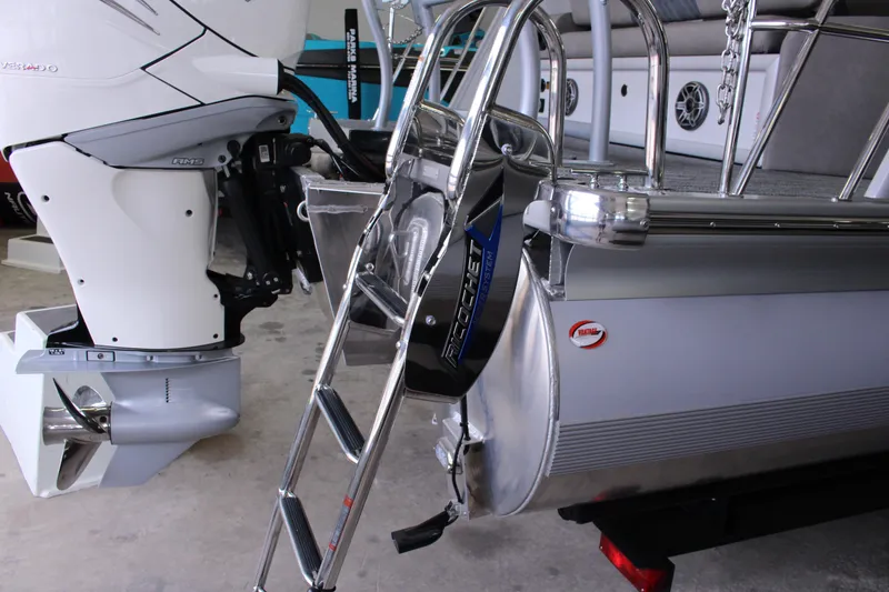 Slide: The Image of 2023 Premier 250 Intrigue boat with outboard motor and ladder in a showroom. - 13
