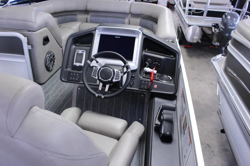Slide: The Image of 2023 Premier 250 Intrigue boat interior with modern steering console and seating. - 16