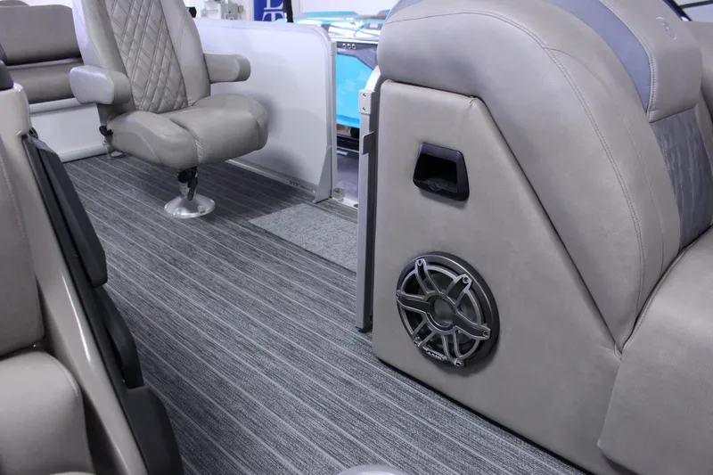 Slide: The Image of 2023 Premier 250 Intrigue interior with gray seating and speaker detail. - 20