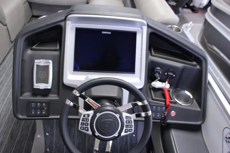 Slide: The Image of 2023 Premier 250 Intrigue boat dashboard with steering wheel and control panel. - 23