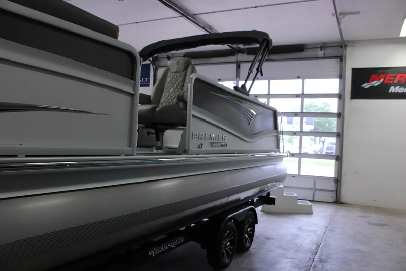 Slide: The Image of 2023 Premier 250 Intrigue pontoon boat in a showroom, side view. - 7