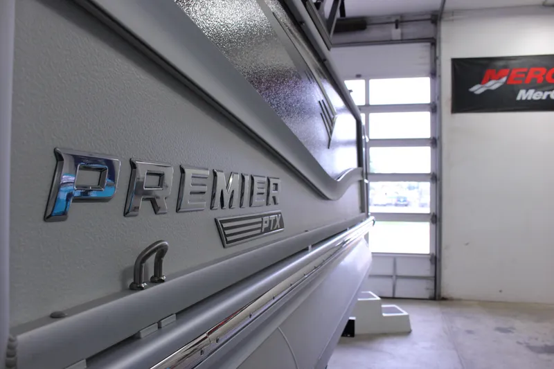 Slide: The Image of 2023 Premier 250 Intrigue boat in showroom, showcasing sleek design and branding. - 8