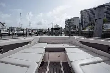 Slide: The Image of 2023 Sea Ray SLX 350 Outboard boat interior with luxurious seating at marina. - 10