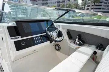 Slide: The Image of 2023 Sea Ray SLX 350 Outboard cockpit with modern controls and sleek design. - 18