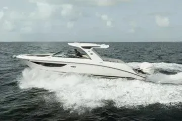 Slide: The Image of 2023 Sea Ray SLX 350 Outboard cruising on open water. - 3