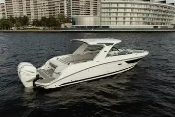Slide: The Image of 2023 Sea Ray SLX 350 Outboard boat on water, cityscape background. - 4