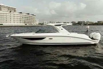 Slide: The Image of 2023 Sea Ray SLX 350 Outboard boat on water, modern design, urban backdrop. - 9