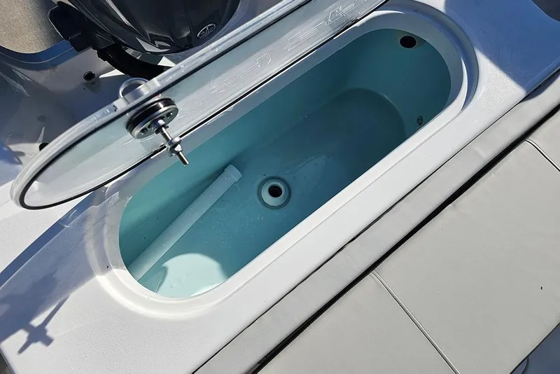 Slide: The Image of Livewell on 2025 Sea Pro 222 Center Console boat, open lid, showing interior. - 15
