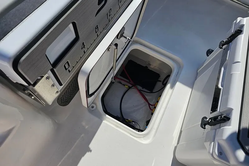 Slide: The Image of 2025 Sea Pro 222 Center Console boat storage compartment with wiring and equipment. - 17