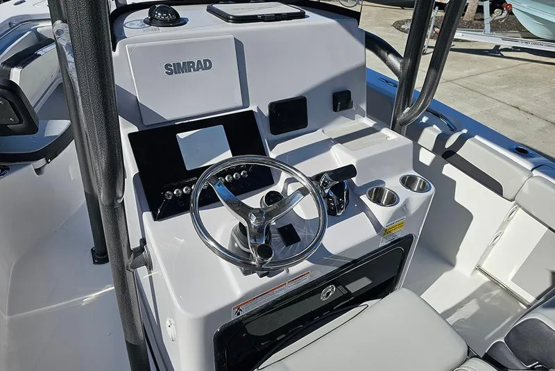 Slide: The Image of 2025 Sea Pro 222 Center Console boat dashboard with steering wheel and controls. - 20