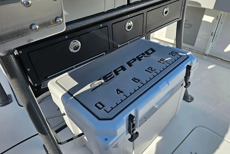 Slide: The Image of 2025 Sea Pro 222 Center Console with storage compartments and branded cooler on deck. - 21