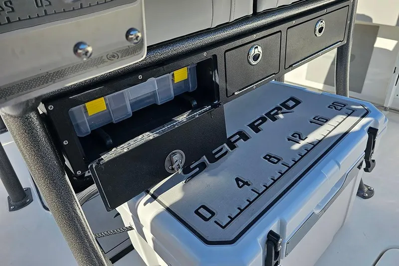 Slide: The Image of 2025 Sea Pro 222 Center Console storage area with drawers and cooler. - 22