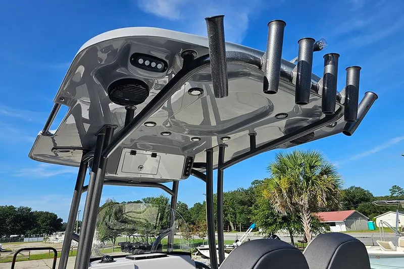 Slide: The Image of 2025 Sea Pro 222 Center Console boat with rod holders and canopy under blue sky. - 23