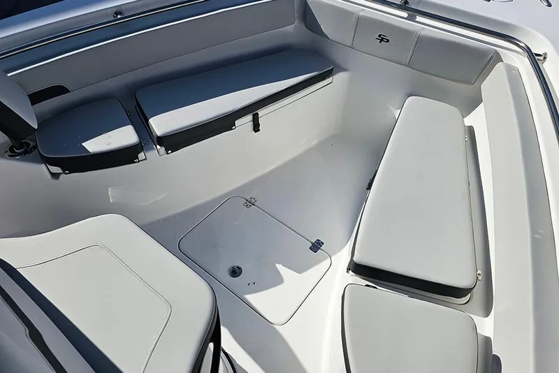 Slide: The Image of 2025 Sea Pro 222 Center Console boat interior with cushioned seating and storage. - 27