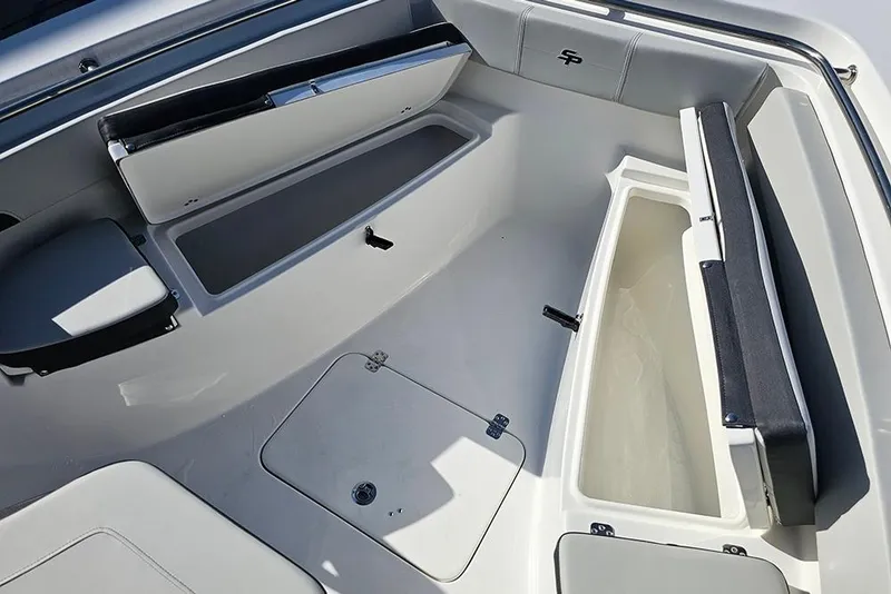 Slide: The Image of 2025 Sea Pro 222 Center Console boat interior with storage compartments open. - 29