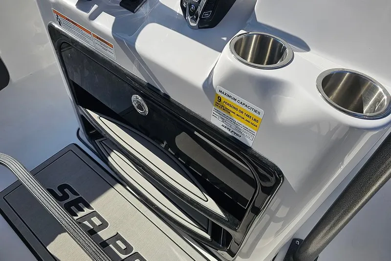 Slide: The Image of 2025 Sea Pro 222 Center Console boat interior with cup holders and capacity label. - 34