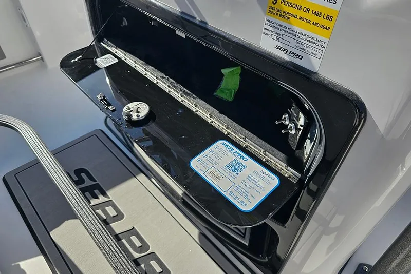 Slide: The Image of 2025 Sea Pro 222 Center Console storage compartment with safety label and Sea Pro branding. - 35
