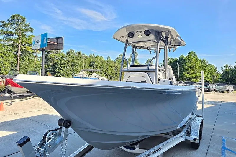 Slide: The Image of 2025 Sea Pro 222 Center Console boat on trailer, displayed outdoors under clear blue sky. - 5
