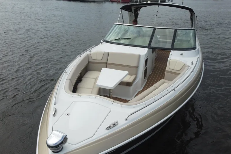 Slide: The Image of 2013 Formula 350 CBR boat with spacious seating and table on calm water. - 11