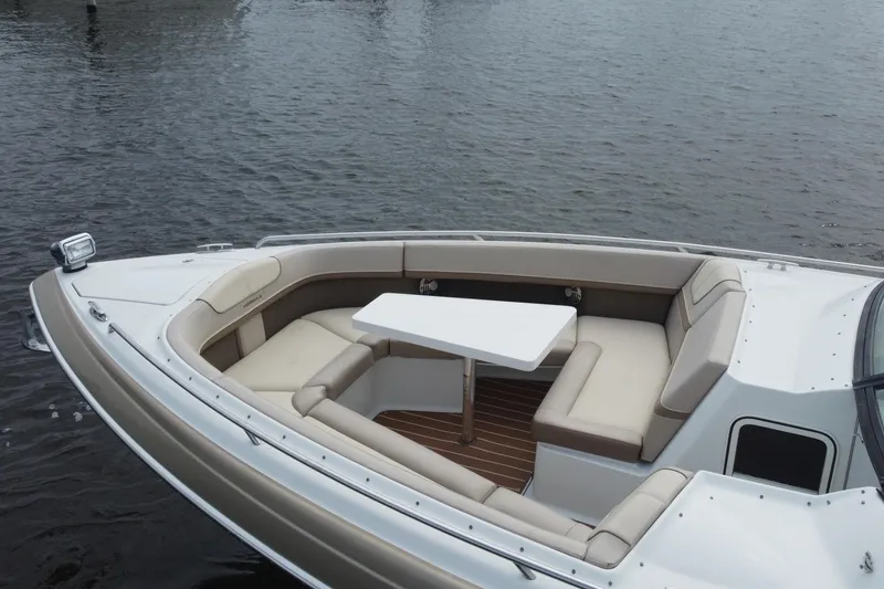 Slide: The Image of 2013 Formula 350 CBR boat with spacious seating and table on calm water. - 12