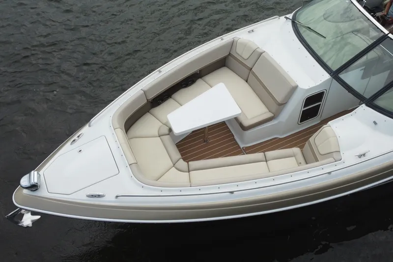 Slide: The Image of 2013 Formula 350 CBR boat with spacious seating and table on calm water. - 16