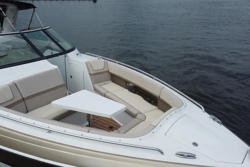 Slide: The Image of 2013 Formula 350 CBR boat with spacious seating and table on calm water. - 18