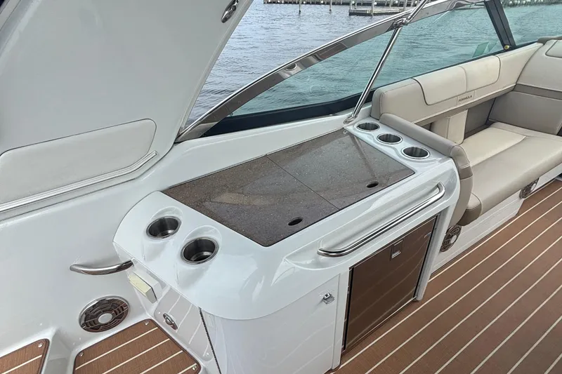 Slide: The Image of 2013 Formula 350 CBR boat interior with seating, cup holders, and countertop. - 20