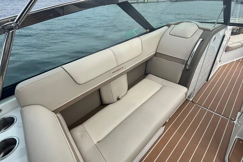 Slide: The Image of 2013 Formula 350 CBR boat interior with beige seating and wood-style flooring. - 22