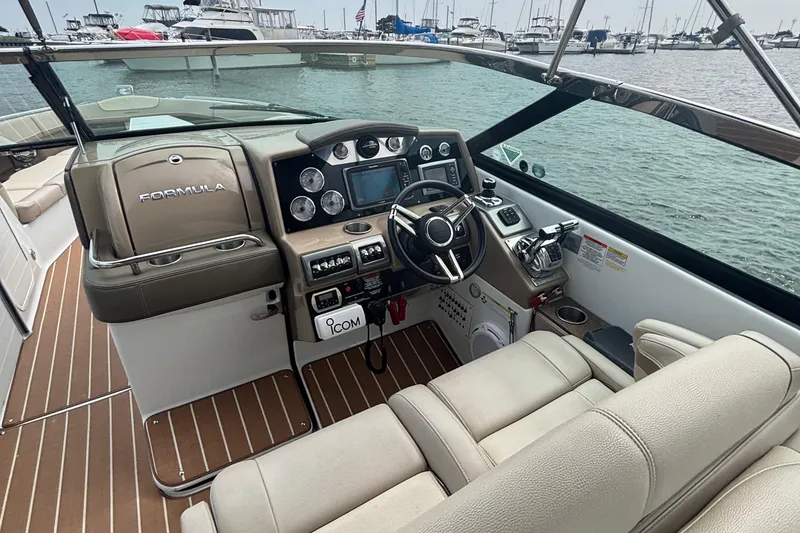 Slide: The Image of 2013 Formula 350 CBR boat cockpit with steering wheel and control panel, docked at marina. - 23