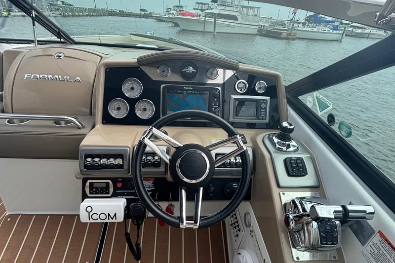 Slide: The Image of 2013 Formula 350 CBR boat dashboard with steering wheel and navigation controls. - 24