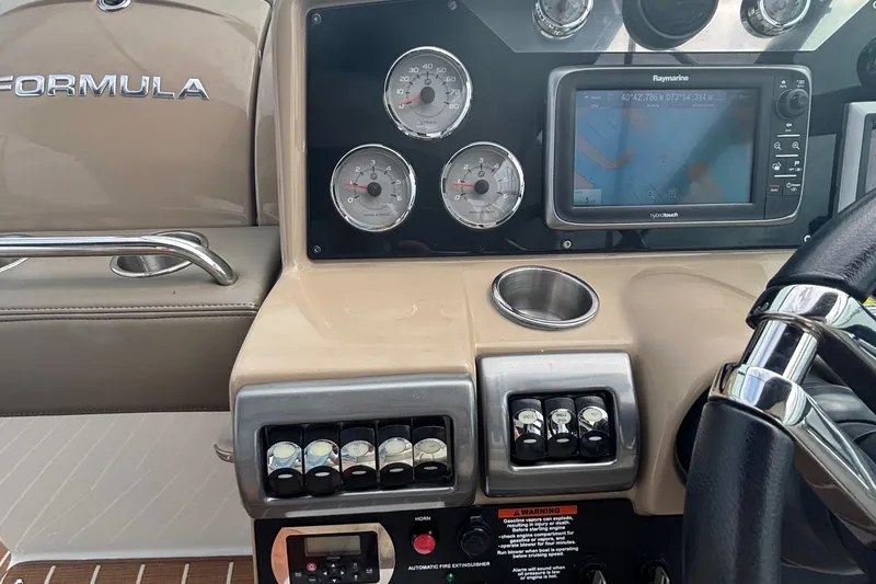 Slide: The Image of 2013 Formula 350 CBR dashboard with gauges, GPS, and control switches. - 26