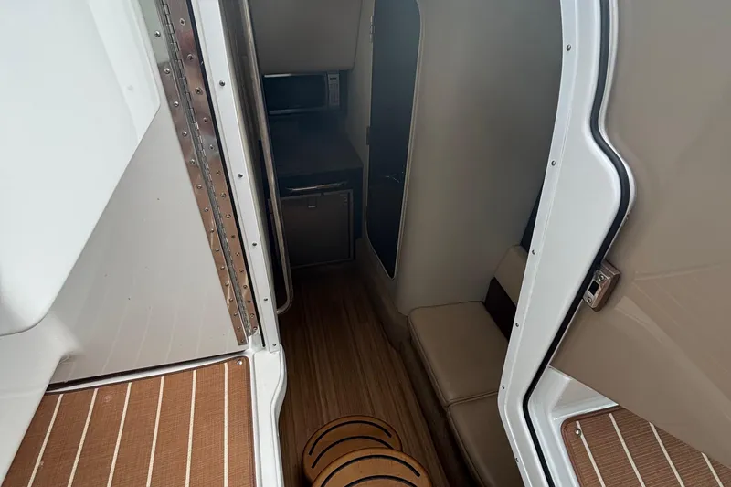 Slide: The Image of Interior view of 2013 Formula 350 CBR boat cabin with seating and wood flooring. - 32