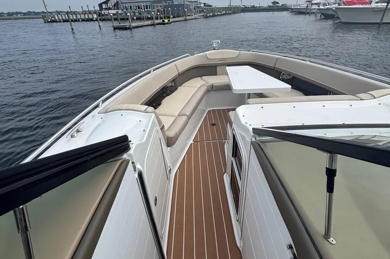 Slide: The Image of 2013 Formula 350 CBR boat with spacious seating and table on calm water. - 33