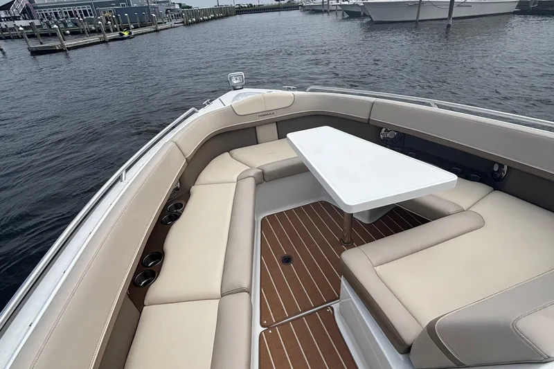 Slide: The Image of 2013 Formula 350 CBR boat interior with beige seating and a white table. - 34