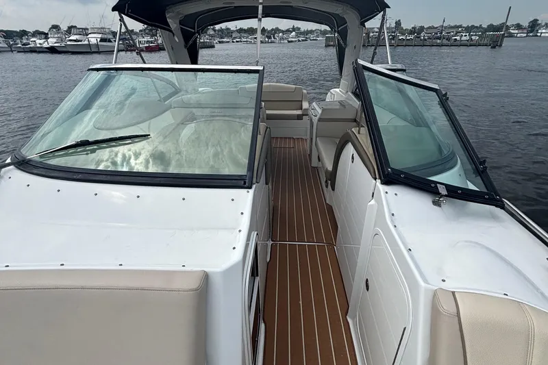 Slide: The Image of 2013 Formula 350 CBR boat with spacious deck and seating, docked by the water. - 37