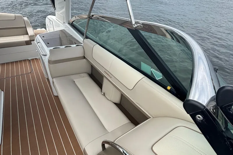 Slide: The Image of 2013 Formula 350 CBR boat interior with beige seating and wood flooring. - 38