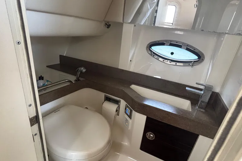 Slide: The Image of 2013 Formula 350 CBR boat bathroom with sink, toilet, and porthole window. - 43