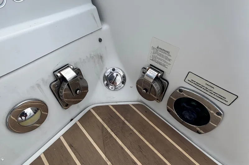 Slide: The Image of 2013 Formula 350 CBR boat deck with utility ports and warning labels. - 52